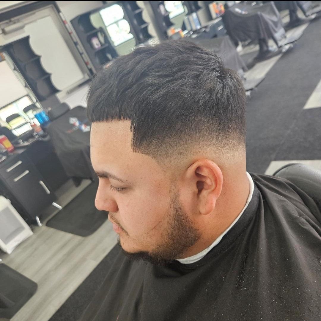 Side view of a men's short crop haircut with a low skin fade and clean line-up, styled at Gem City Barbers in Erie, PA.