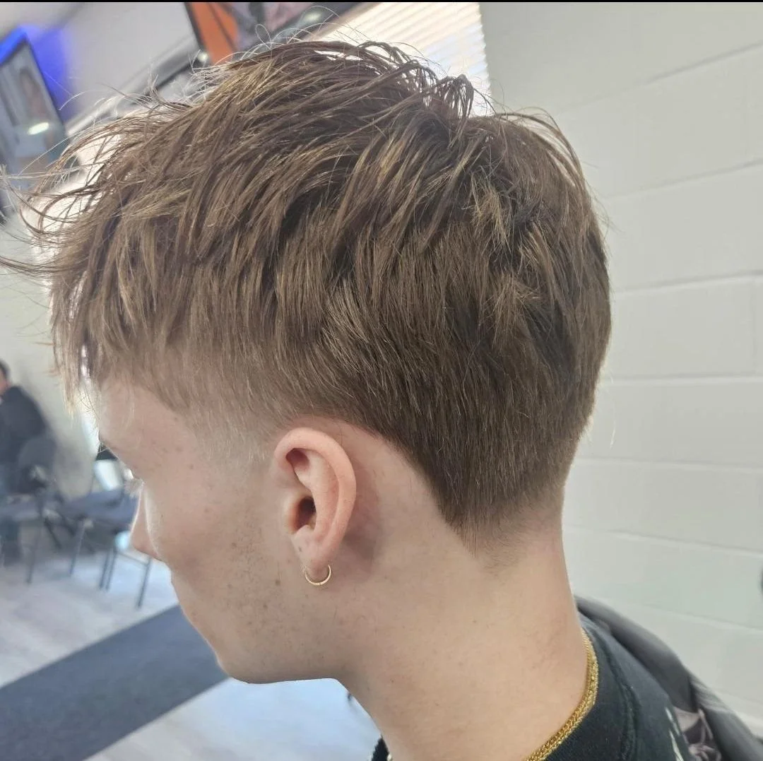 Back and side view of a men's textured crop with choppy layers and a tapered neckline, done at Gem City Barbers in Erie, PA.