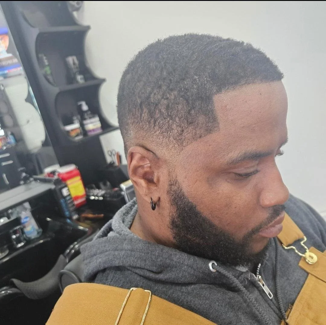 Side view of a men's waves haircut with a temp fade, sharp edge-up, and shaped beard, cut by Ben Santiago at Gem City Barbers in Erie, PA.