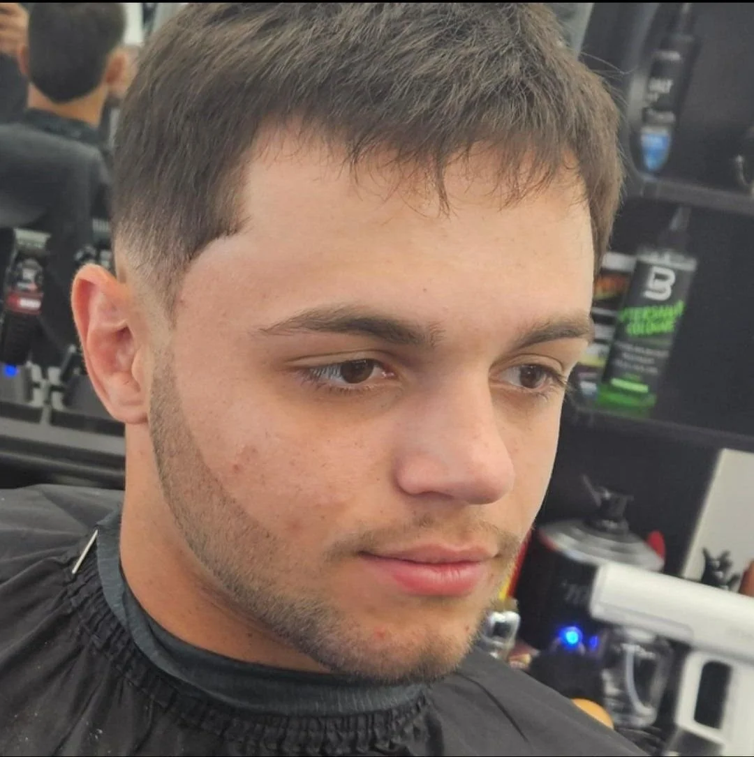 Front view of a men's short textured fringe haircut with a natural finish and subtle taper, done at Gem City Barbers in Erie, PA.