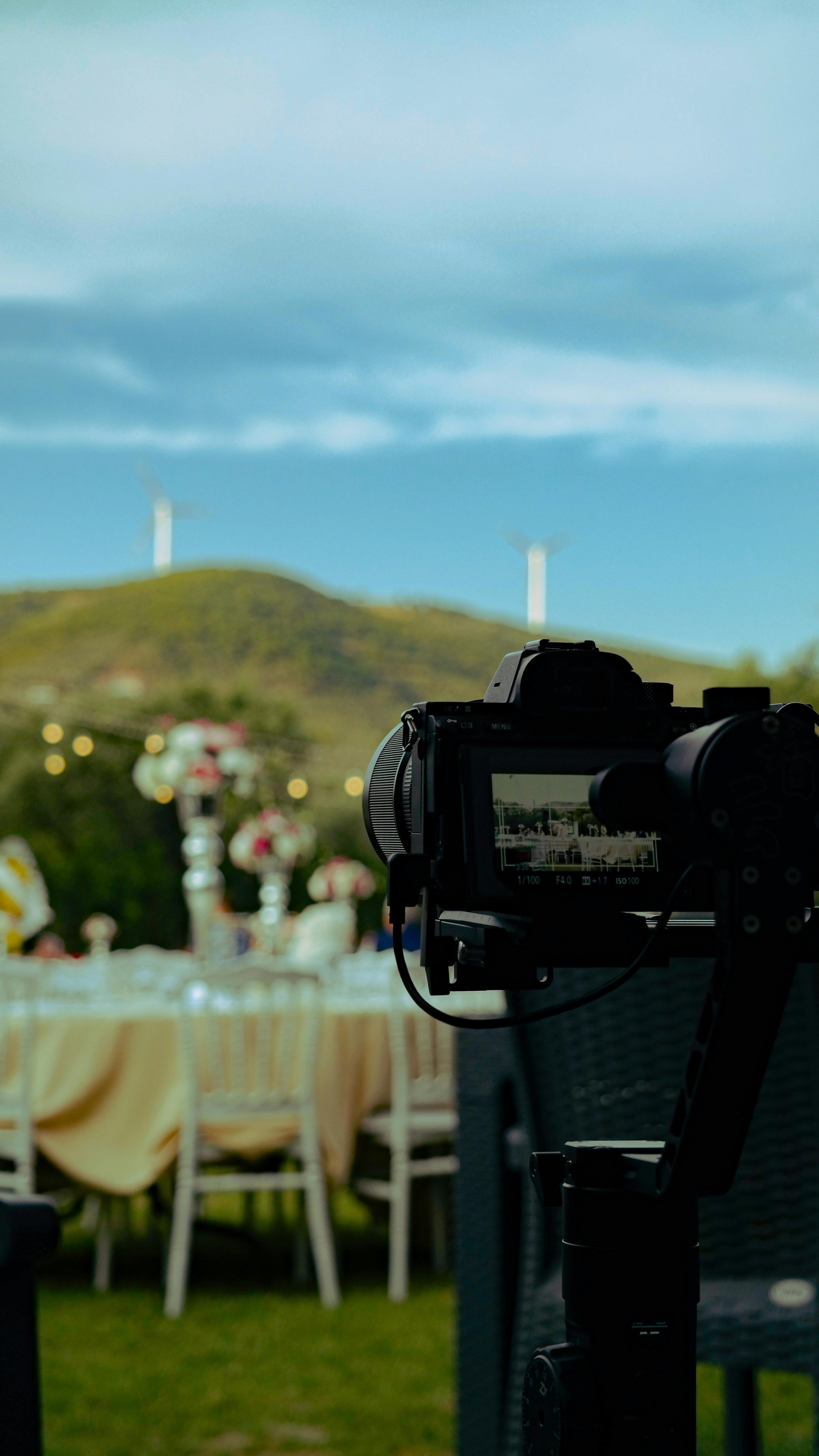 Flowers on the table being captured at a live event.