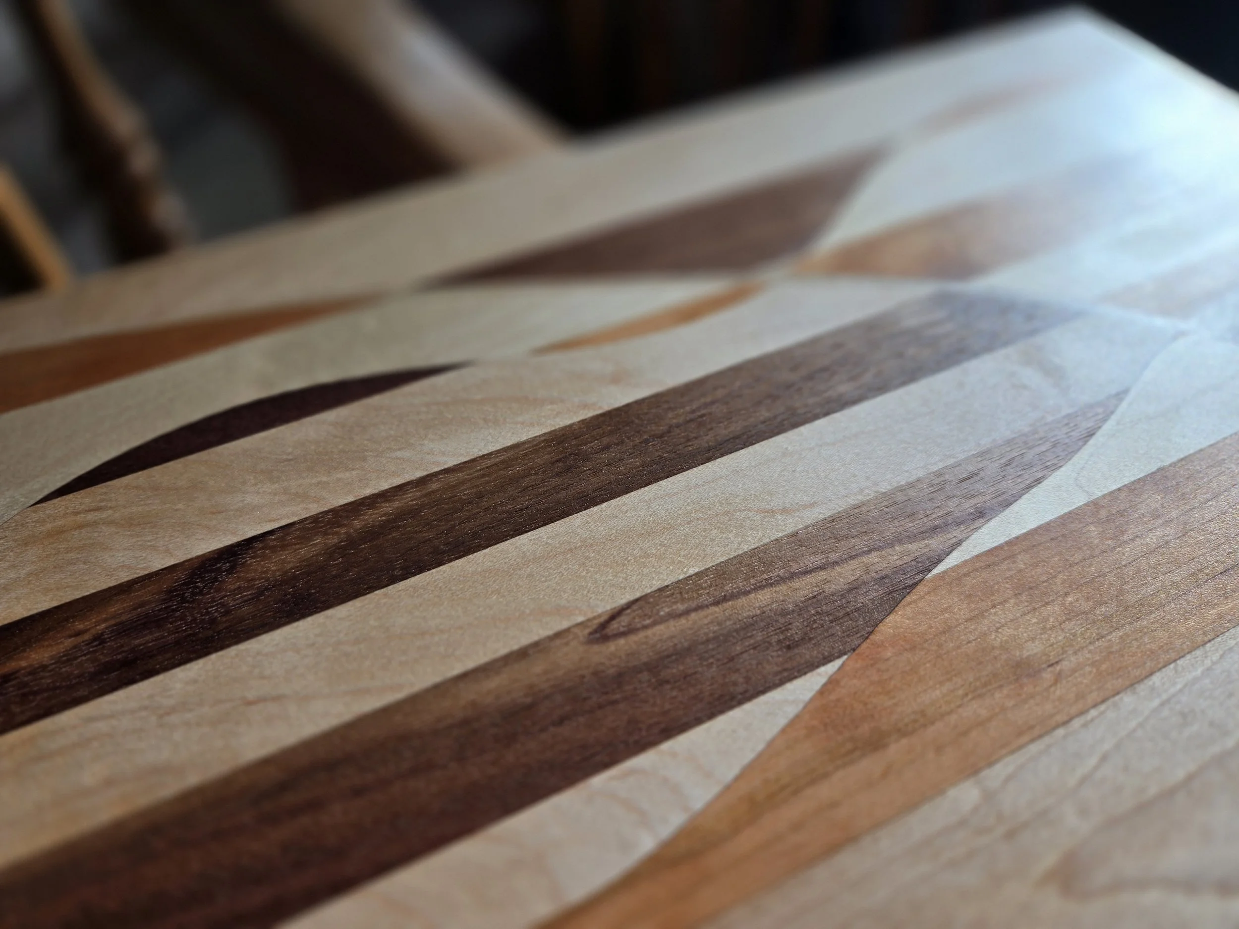 Close-up of a wooden surface with a striped pattern in various shades of brown and beige.