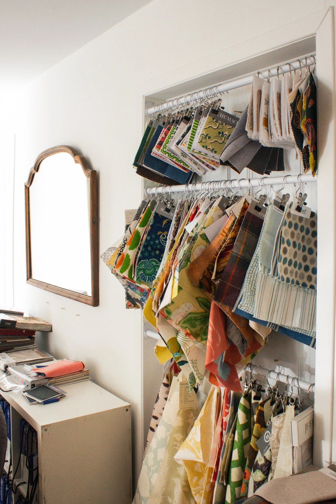 Fabric swatches hanging on rods in Atelier Hopkins' store.