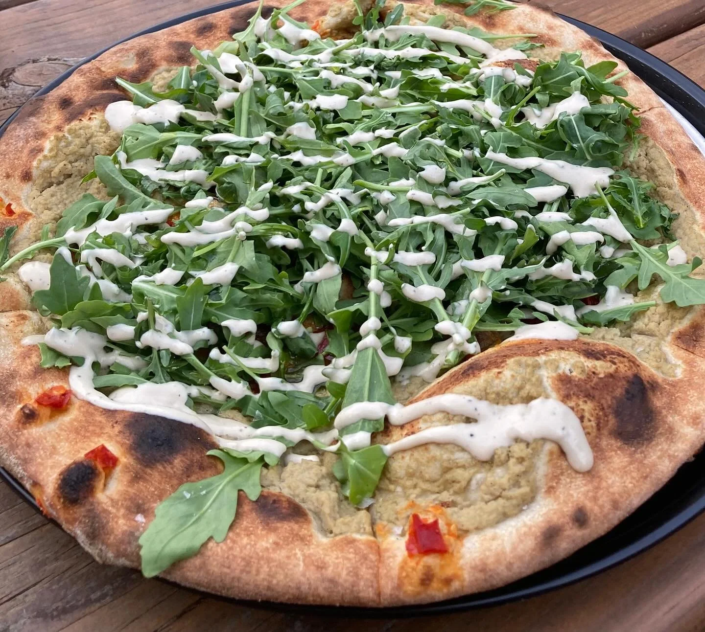 Try The Demeter and cool off with some Mediterranean vibes. Babaganoush, roasted garlic, and Calabrian chili base. Finished with arugula and tahini. For when you want a salad but your brain ordered pizza instead.
