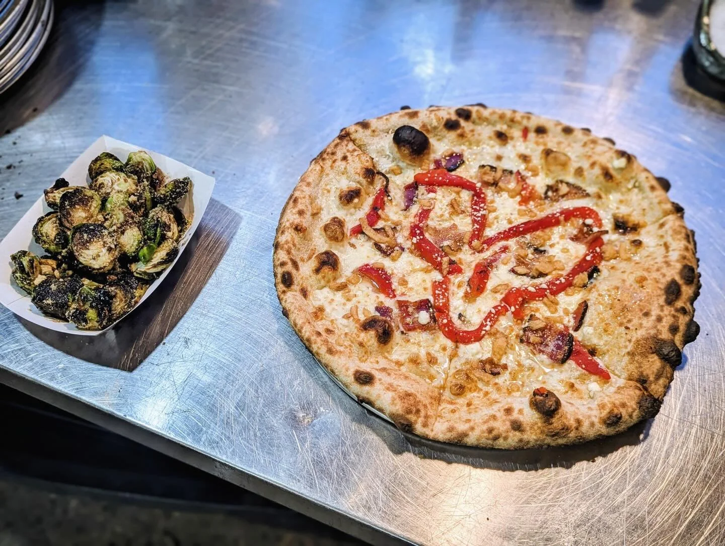We love love... and pizza! Come celebrate Valentine's Day with us, your special someone, or your favorite friends and our 💘 Pear of My Eye 💘, which features a white pizza, bacon, goat cheese, roasted red peppers, and finished with a heart of pear r