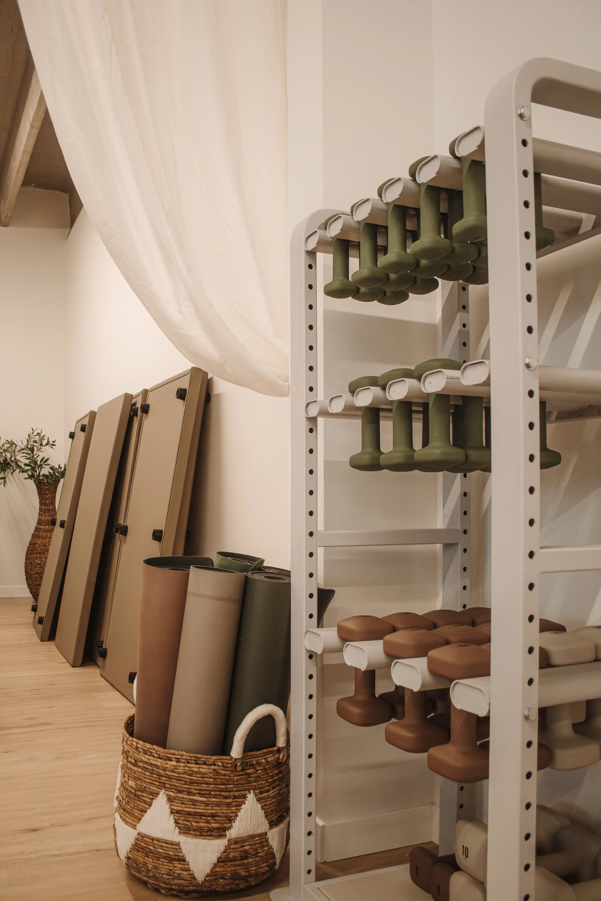 Pilates studio interior with reformers and neatly organized equipment