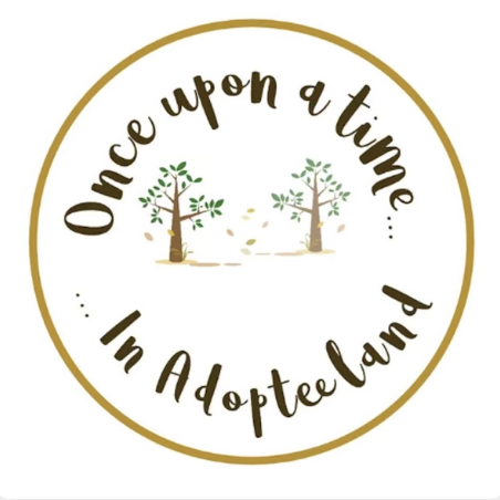 A circular logo with a gold border, featuring two trees in the center and the text "Once upon a time... In Adopted Land" arranged around the trees.