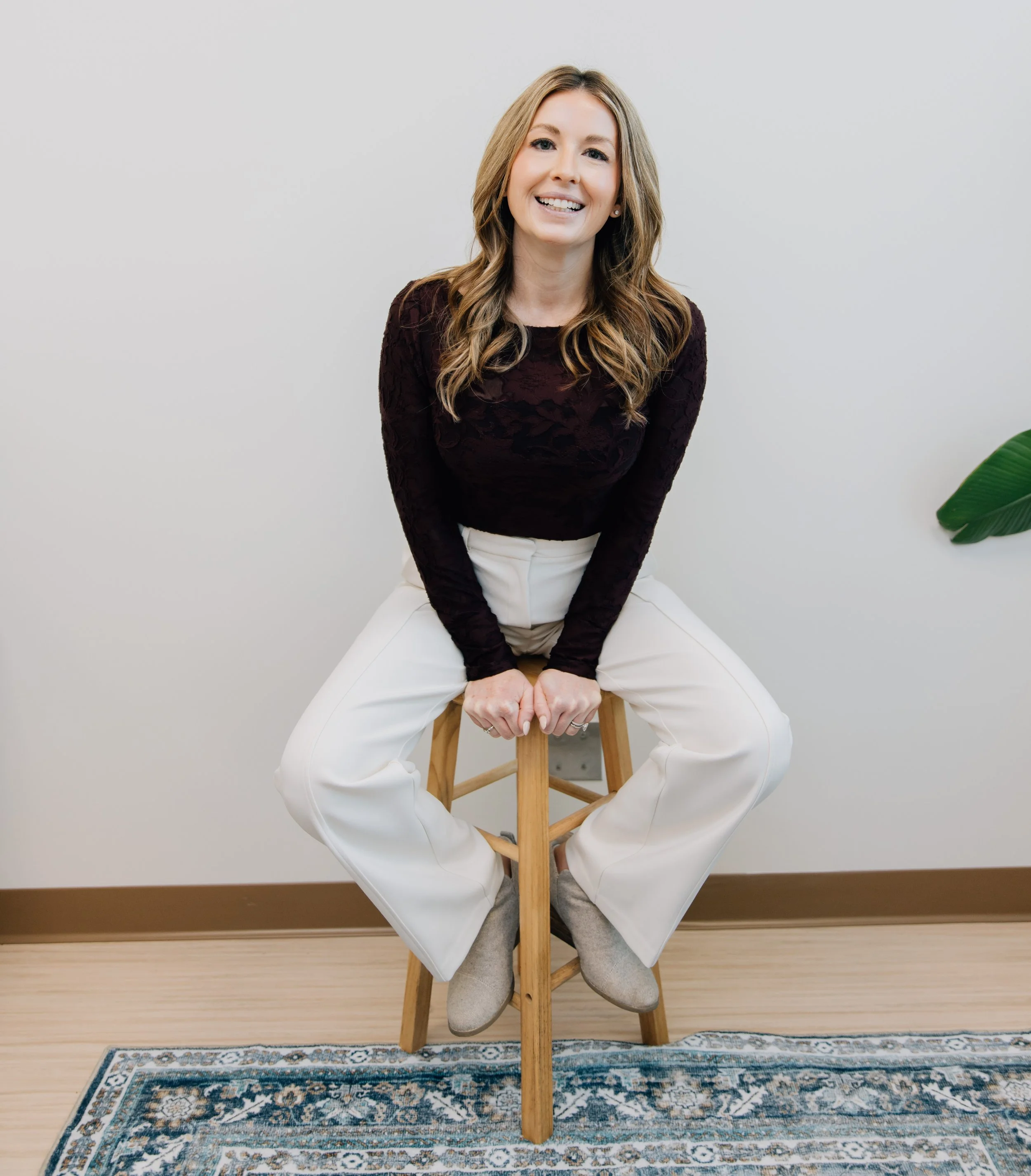 A psychotherapist in an office setting on a stool. Professional photo.