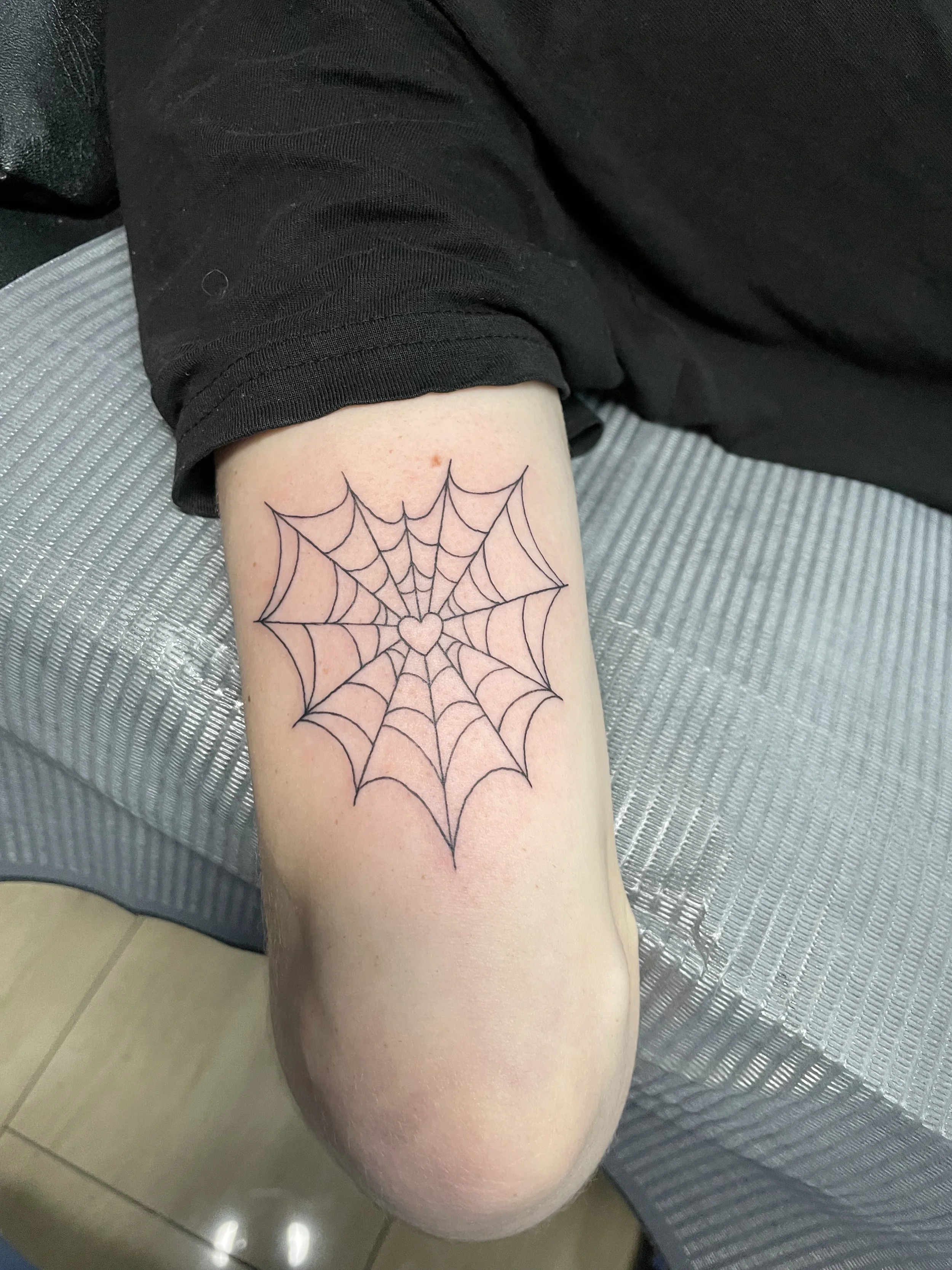 heart spiderweb fine line tattoo