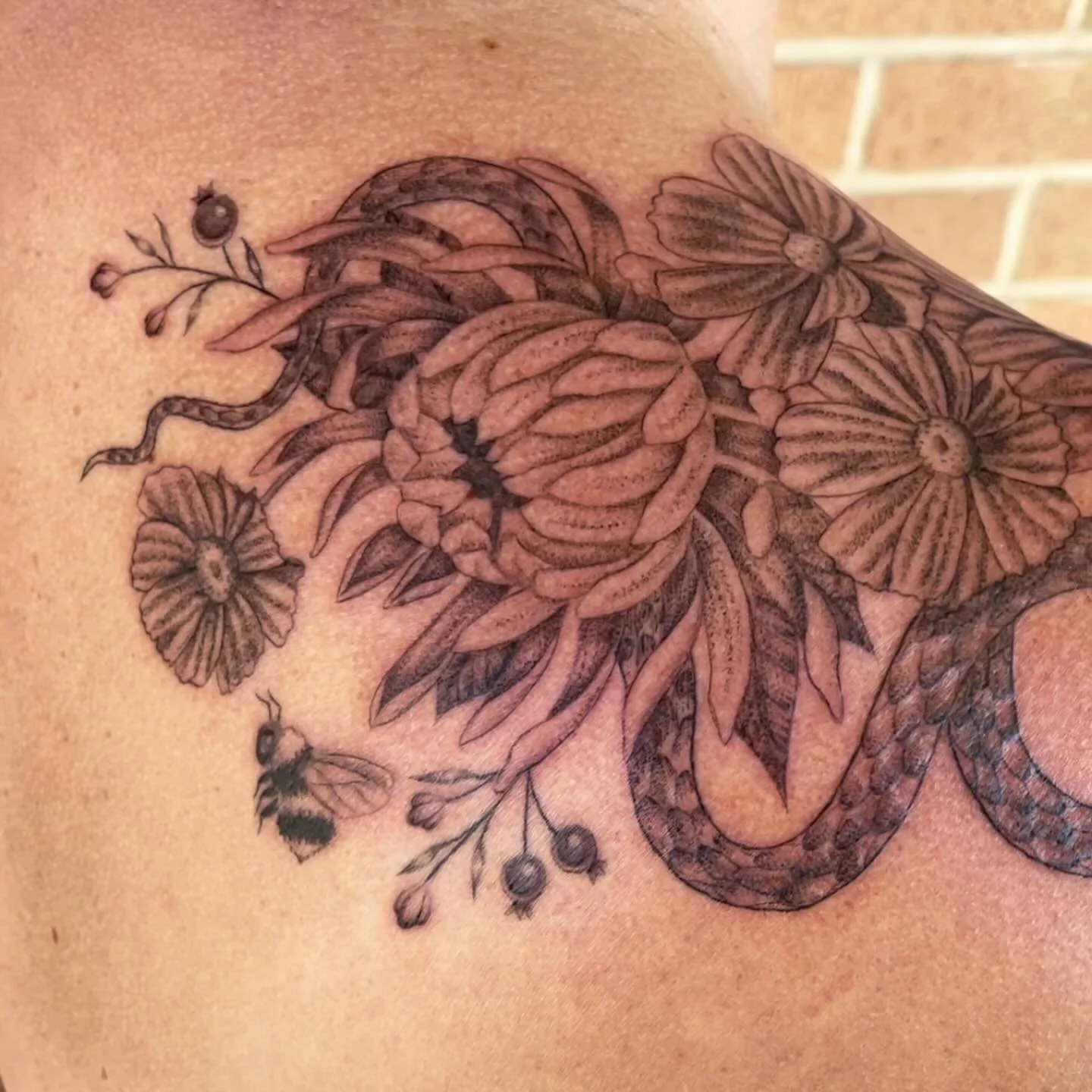 black and grey chrysanthemum tattoo with snake and bee