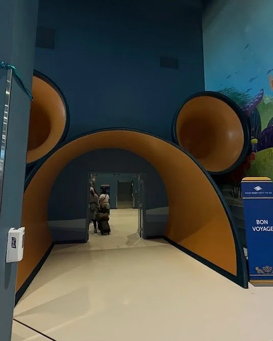 POV: You just stepped into the terminal at Disney Cruise Line, and suddenly real life feels very far away. 

You walk through that giant Mickey portal, hear the excitement buzzing around you, and for the first time in a long time, your only job is to