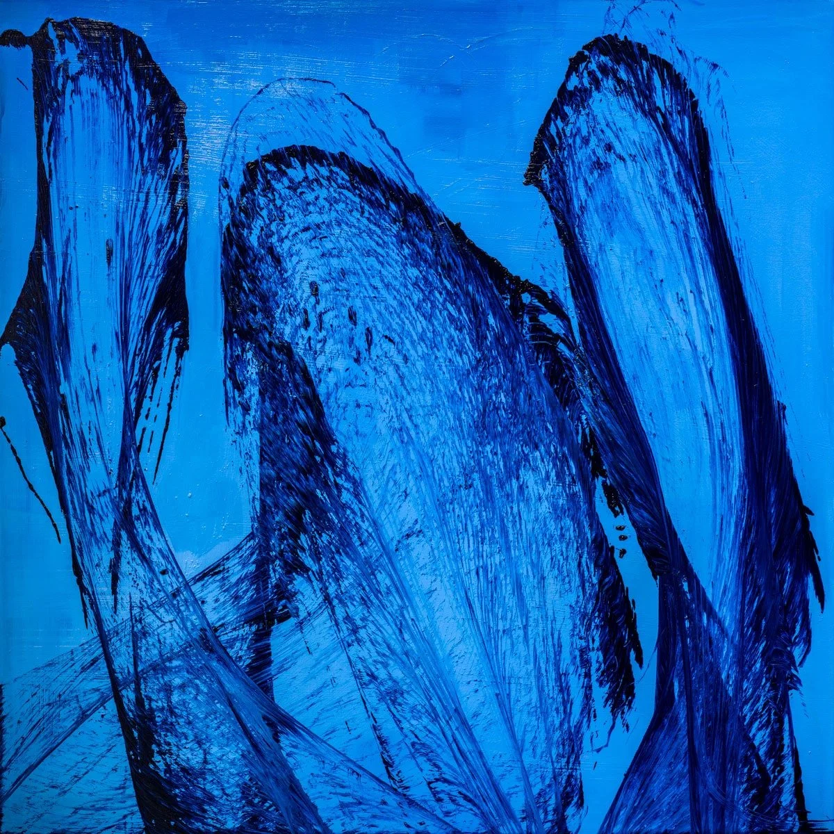 Three dark thread forms rising through blue
