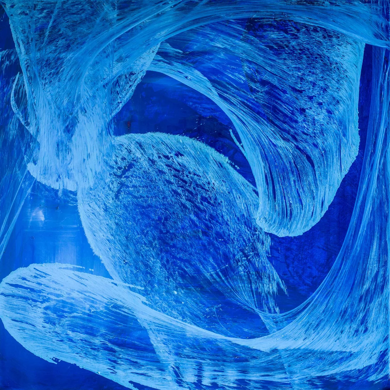 Pale thread churning through a deep blue field