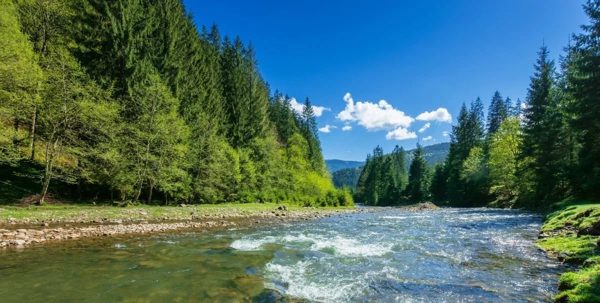 Mountain rocky river. When you combine somatic healing techniques, energy work, and spiritual coaching you release emotional blocks, heal trauma, and begin to express your core essence.