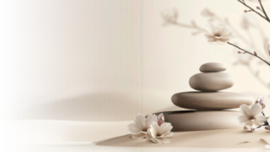 Stacked grey rocks in the sand with white flowers. Intuitive healing and life coaching supports those who feel stuck, emotionally, mentally, physically, or energetically. Services are offered virtually or in person in the Gallatin Valley.
