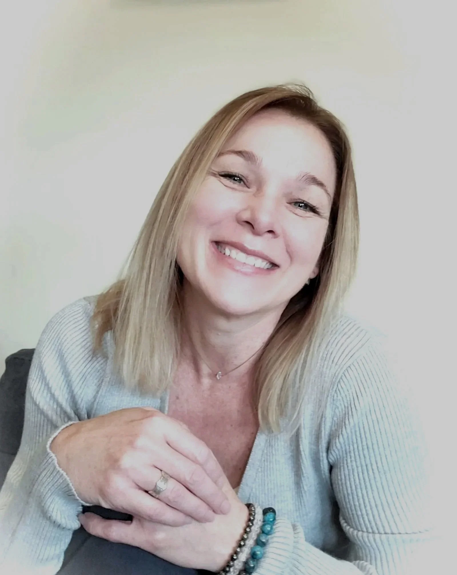 Sarah sitting in a chair. I'm a Certified Master Healer and Spiritual Coach. Take a journey with me into the depths of you. You have all of the answers within you.