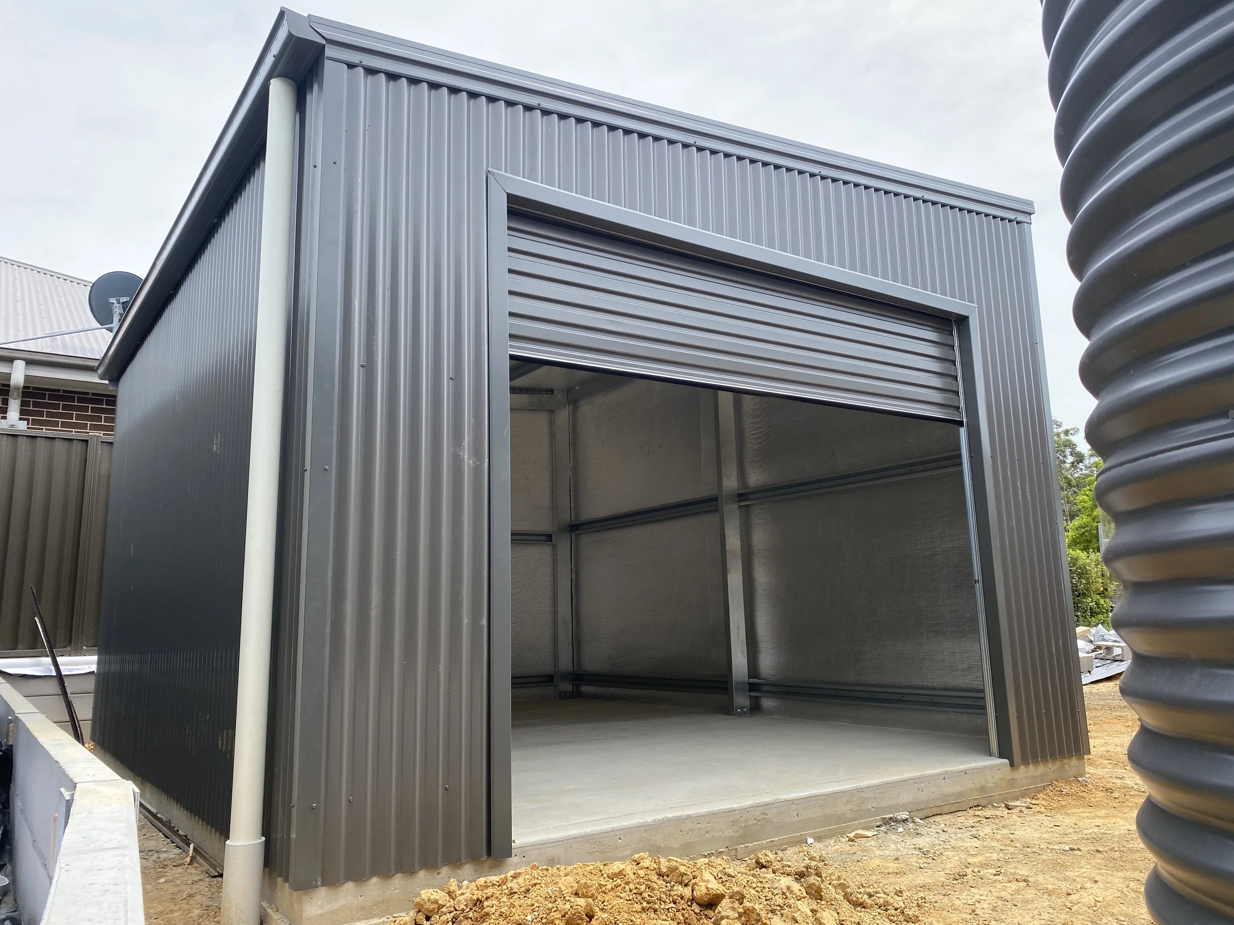 Grey shed with roller door