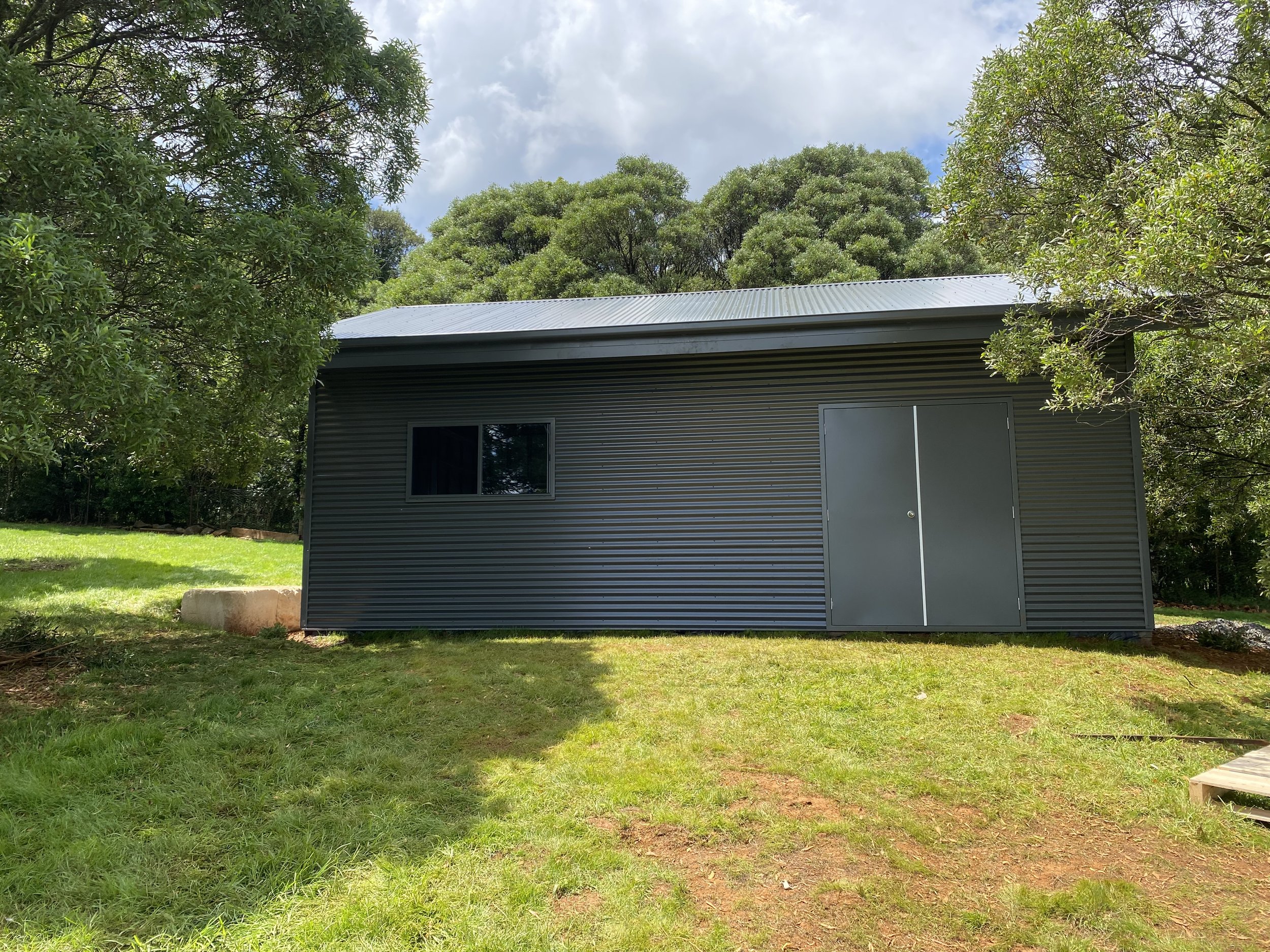 Black shed with doors