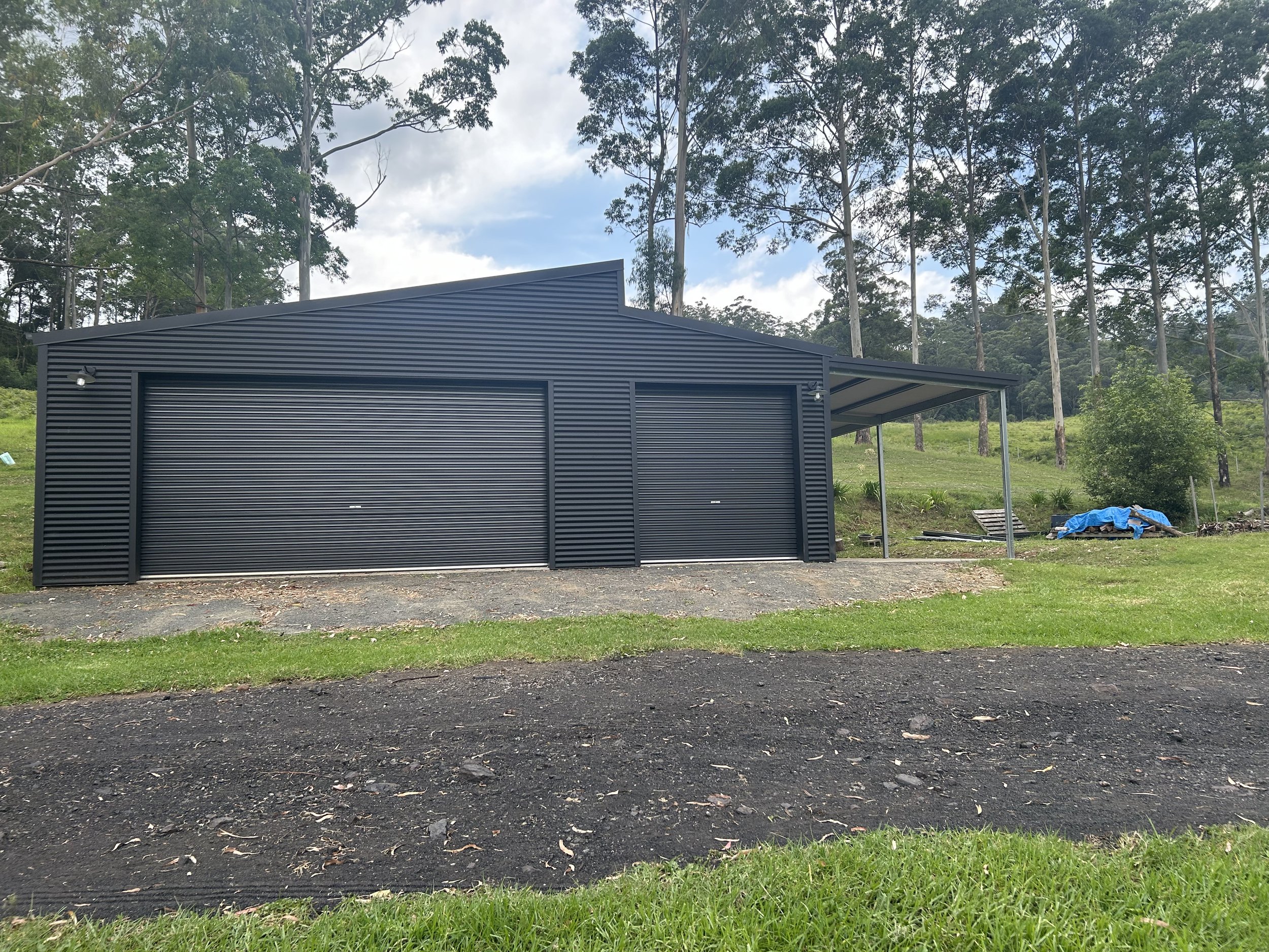 Black shed with 2 roller doors