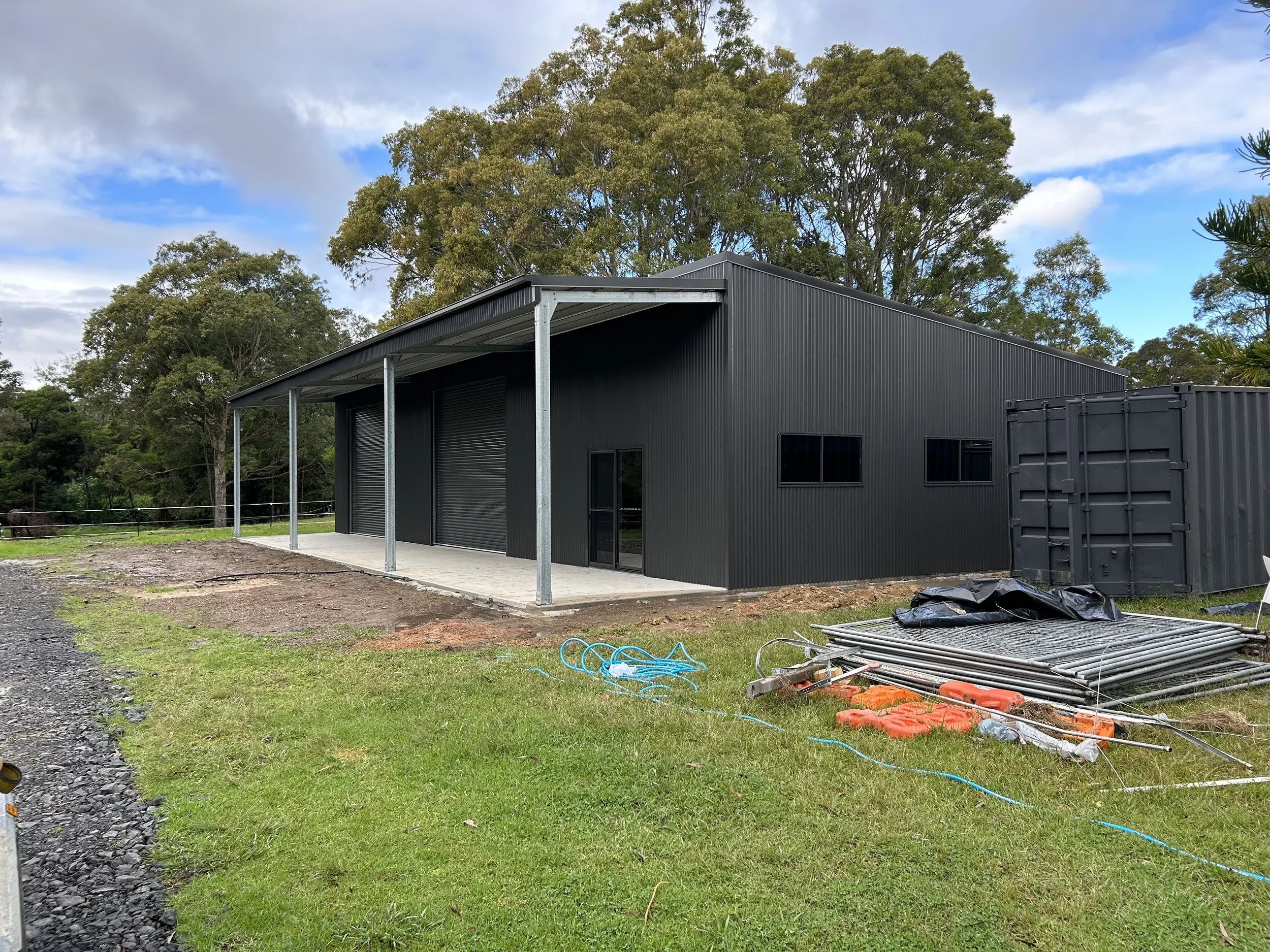 Black double roller door shed with verandah