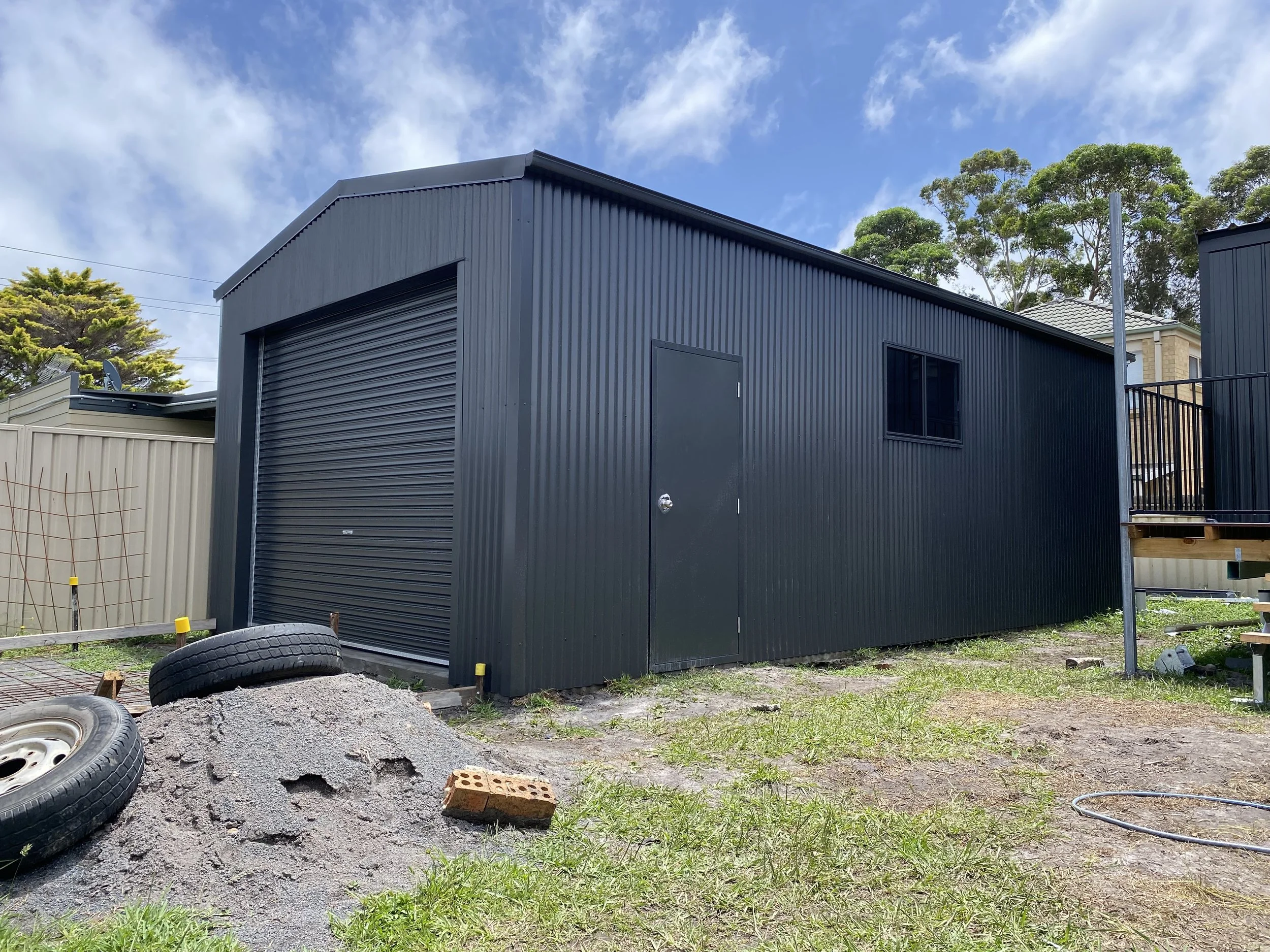 Shed with roller door, door and window, gable roof