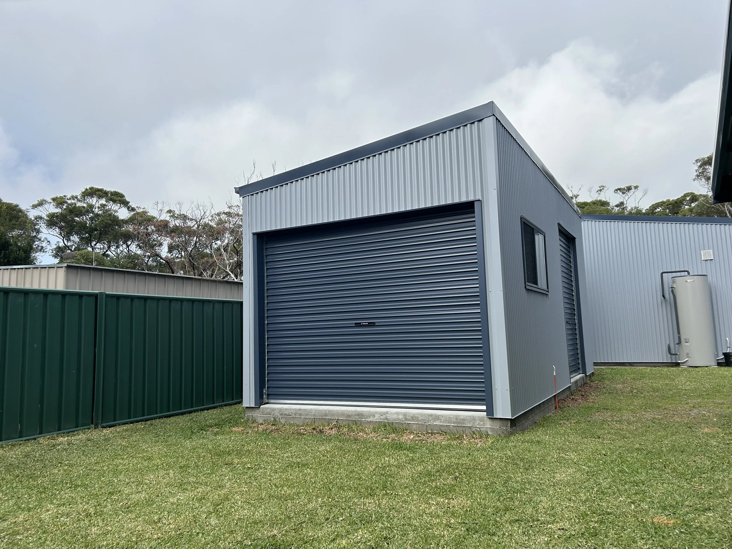 Grey shed with roller door