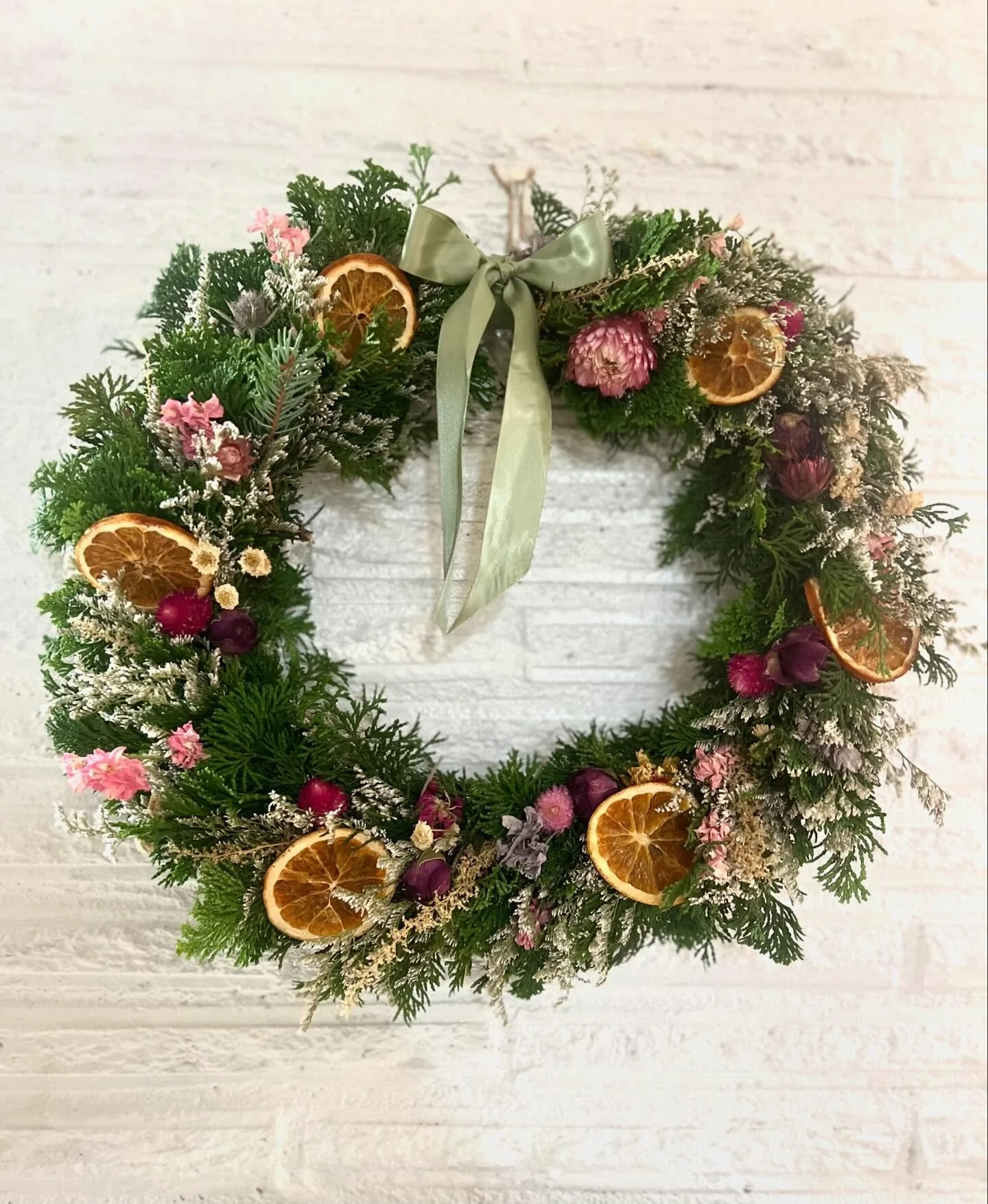 These two smaller holiday wreaths now available 🌙  Round cypress loaded with dried flowers and orange rounds $30 (14&rdquo;), and the simple small crescent moon is $15