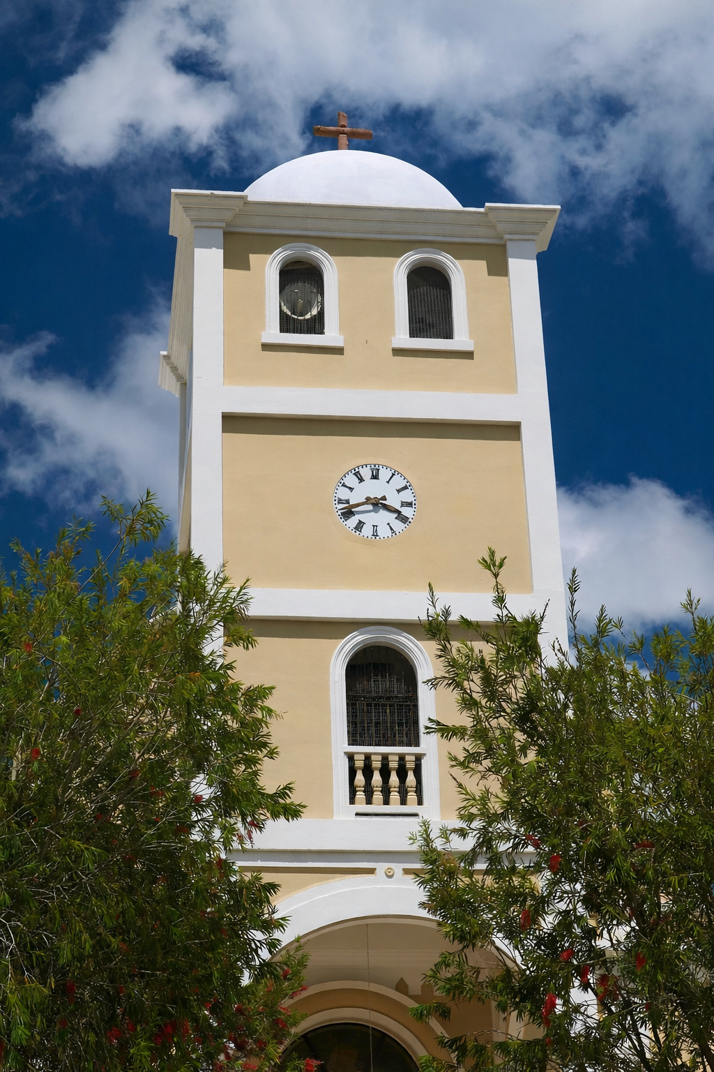 Yellow bell tower on a sunny day.png