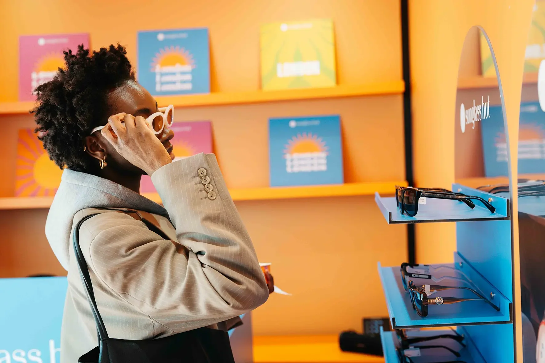Sunglass Hut Pop-up, Customer trying on sunglasses