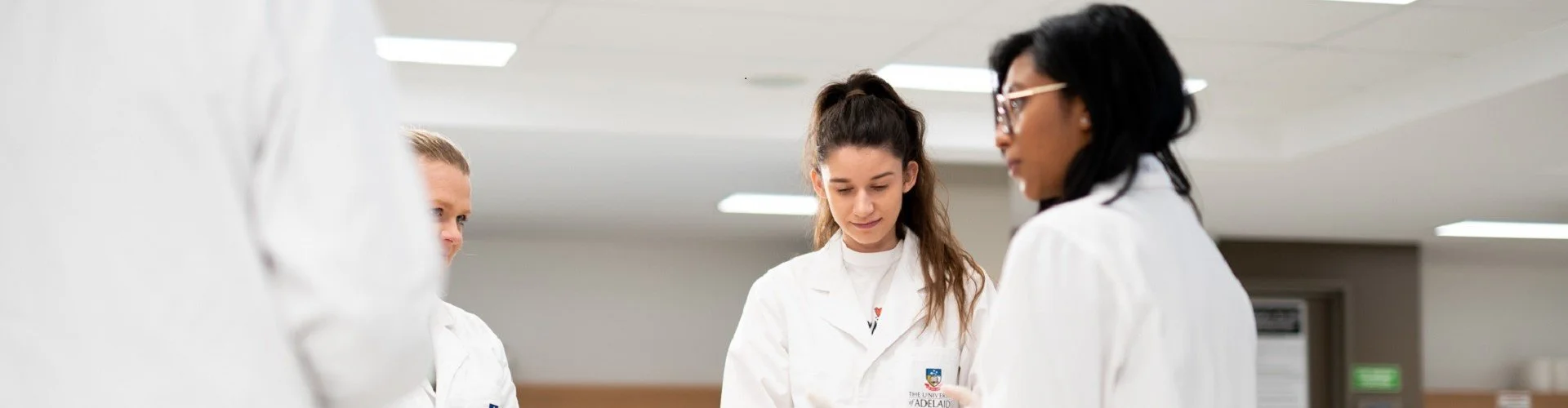Group of people in lab coats in a laboratory setting