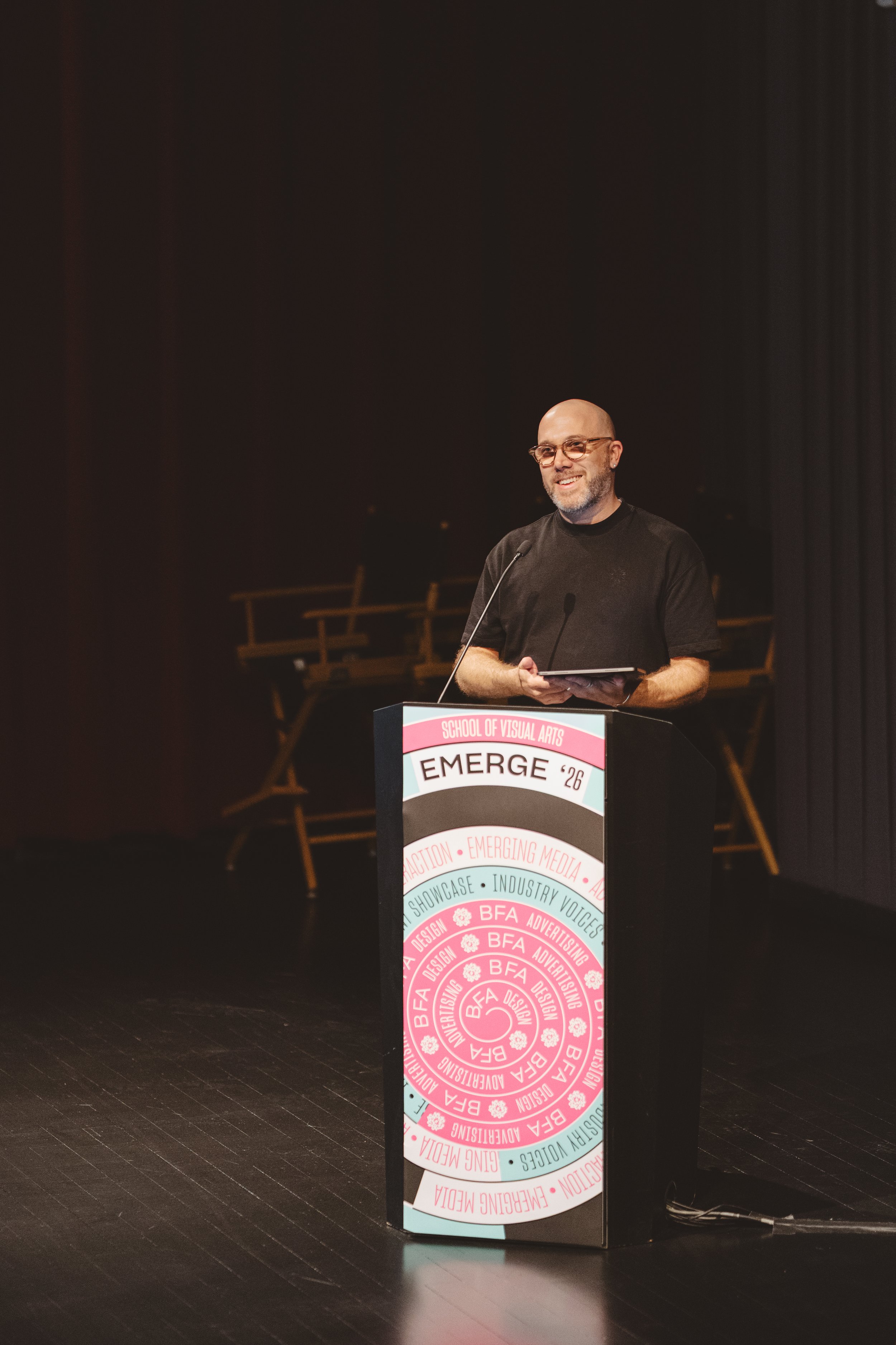 conference-host-speaking-on-stage.JPG