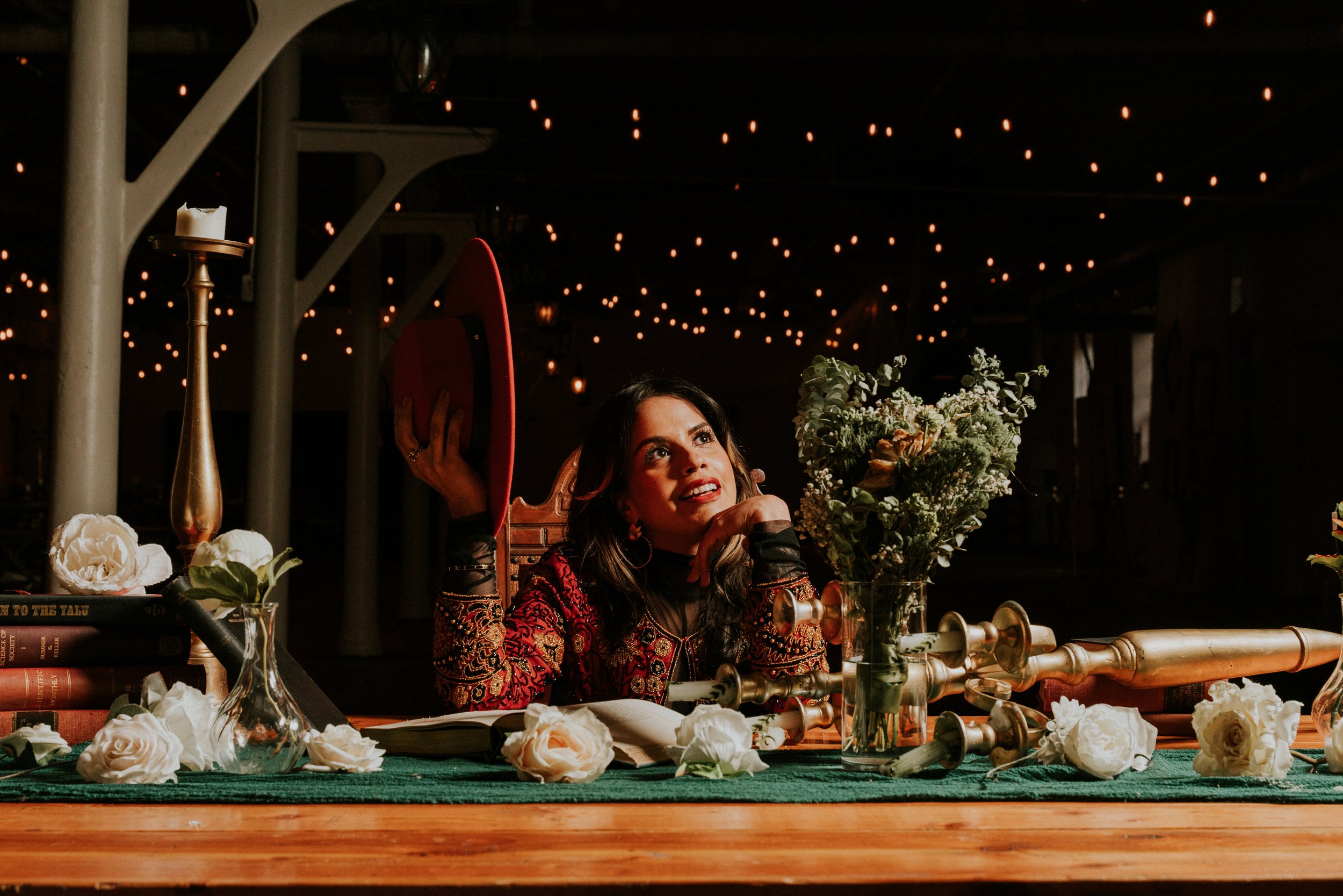 Editorial portrait with red jacket, hat, and floral set design, Art Factory Paterson NJ