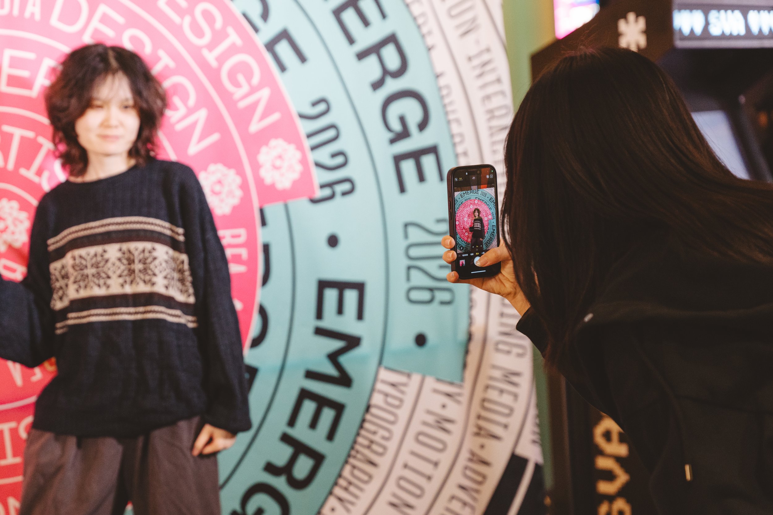 event-guest-taking-photo-at-branded-backdrop.JPG
