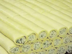 Stack of yellow rolled fabric or possibly foam with a soft, textured surface.