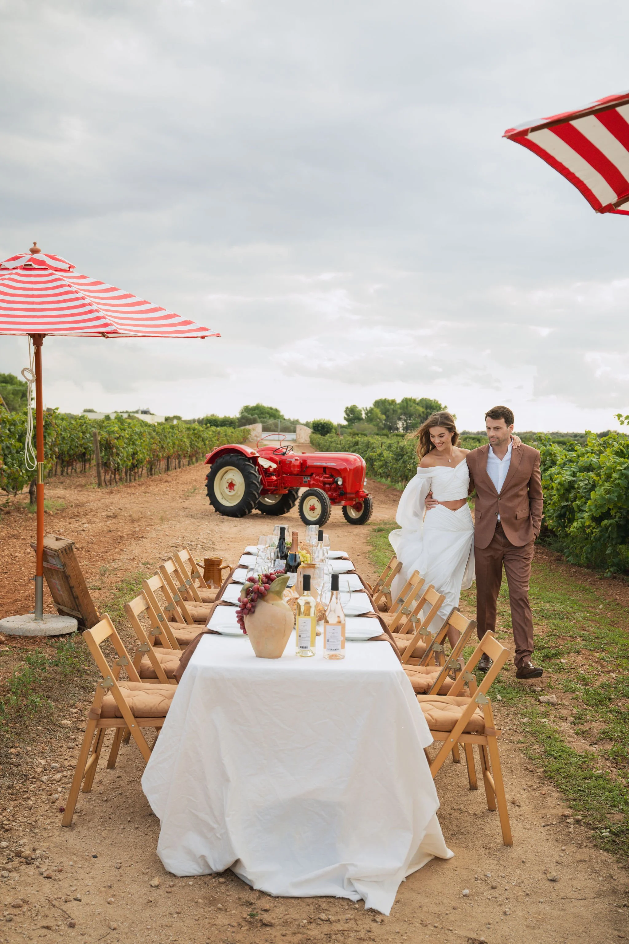 Stone courtyard with ivy-covered wall, arched doorway, and ancient building architecture under blue sky.