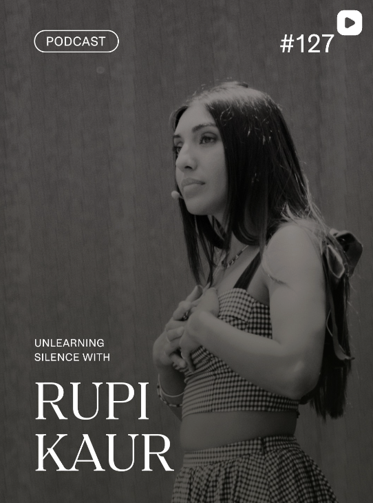 Black and white photo of a woman standing with arms crossed, looking to the side, with text indicating a podcast episode titled 'Unlearning Silence with Rupi Kaur'.