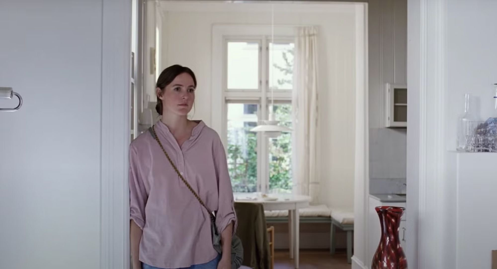 Woman in light pink blouse in bright minimalist room - Sentimental Value
