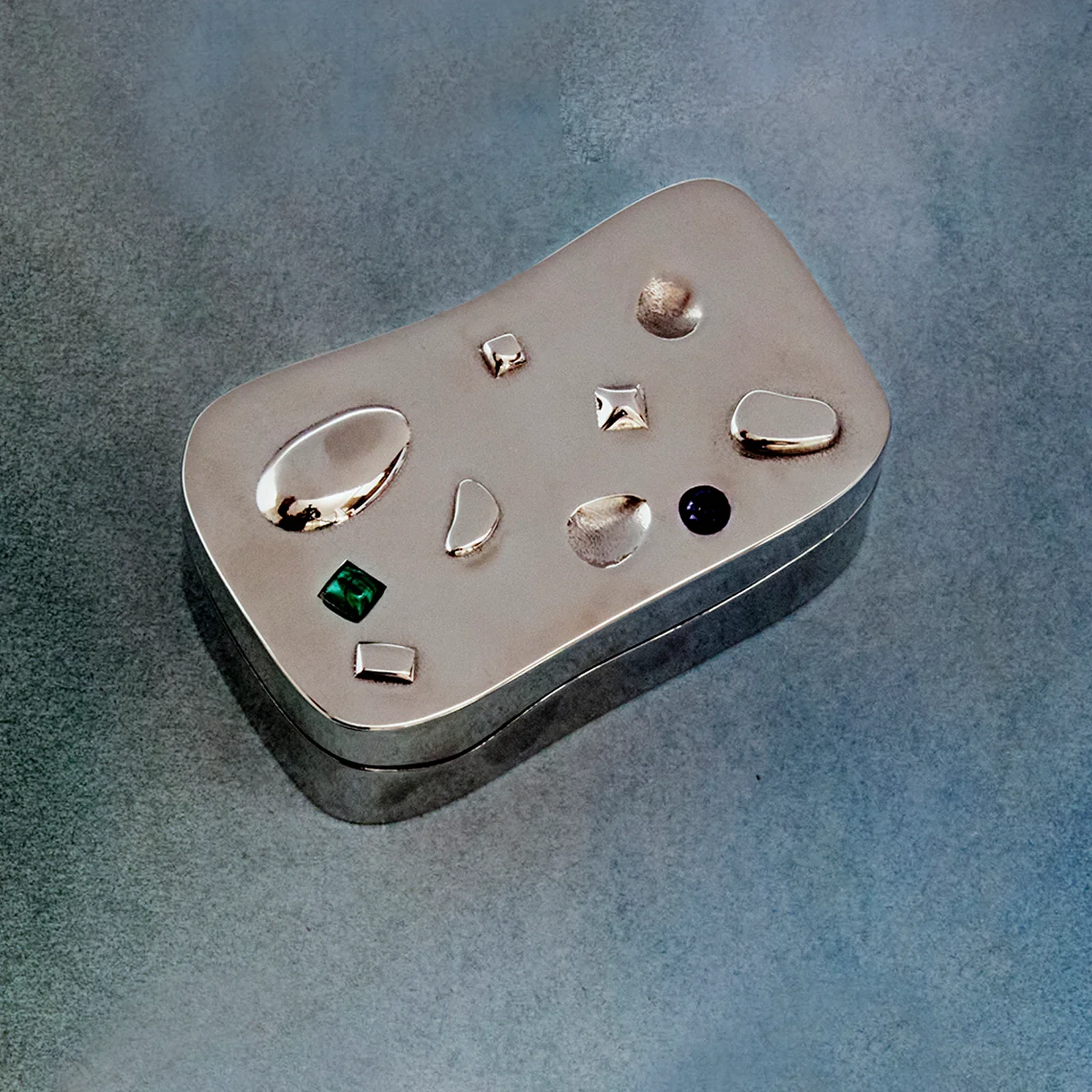 Jewelry pieces in a small metal box