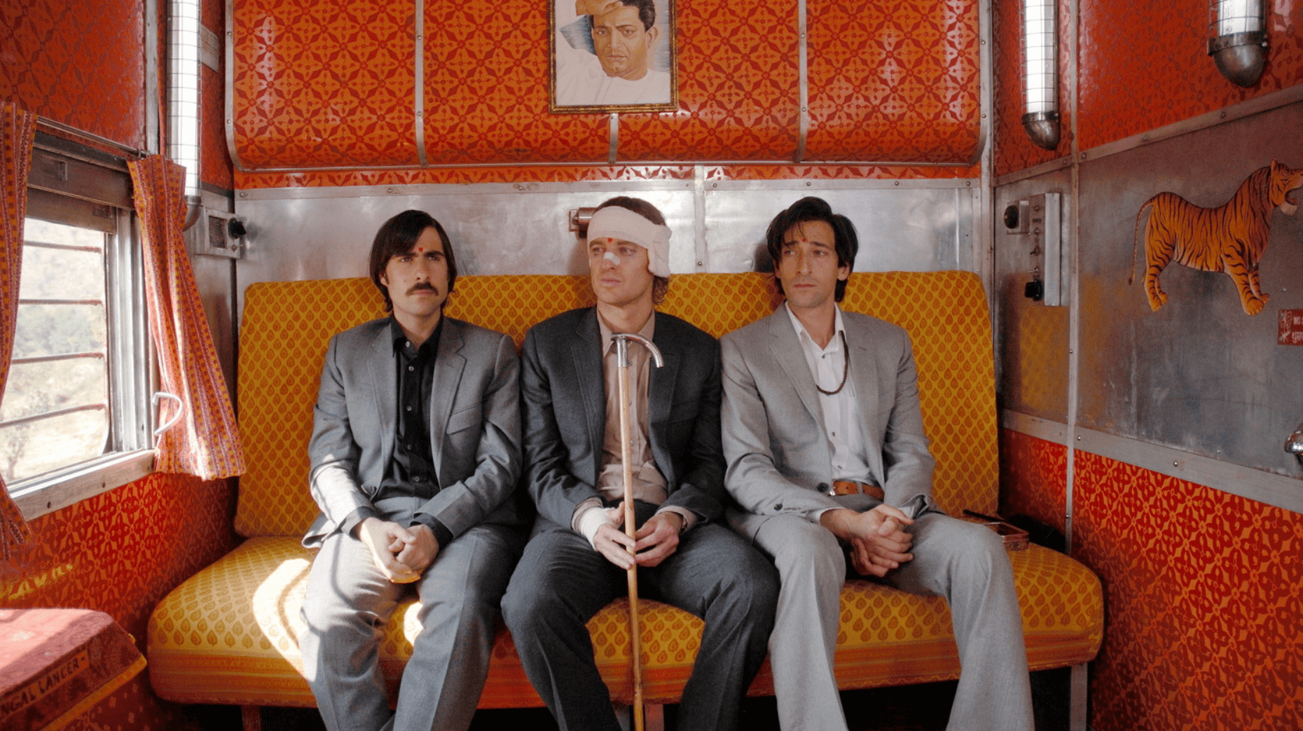 Three men in suits on a train - Darjeeling Limited