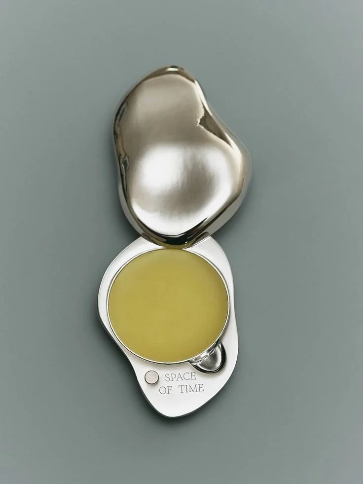 Open tin balm with “SPACE OF TIME” on lid