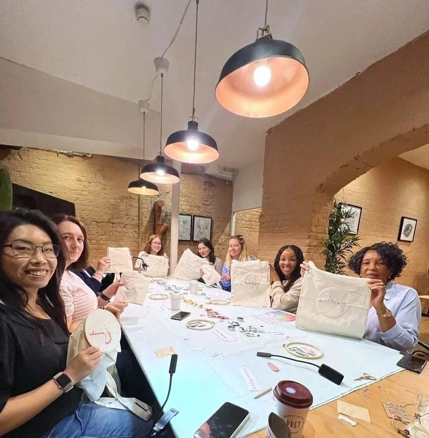 Students showcasing their work during a "Tote and Quote" class