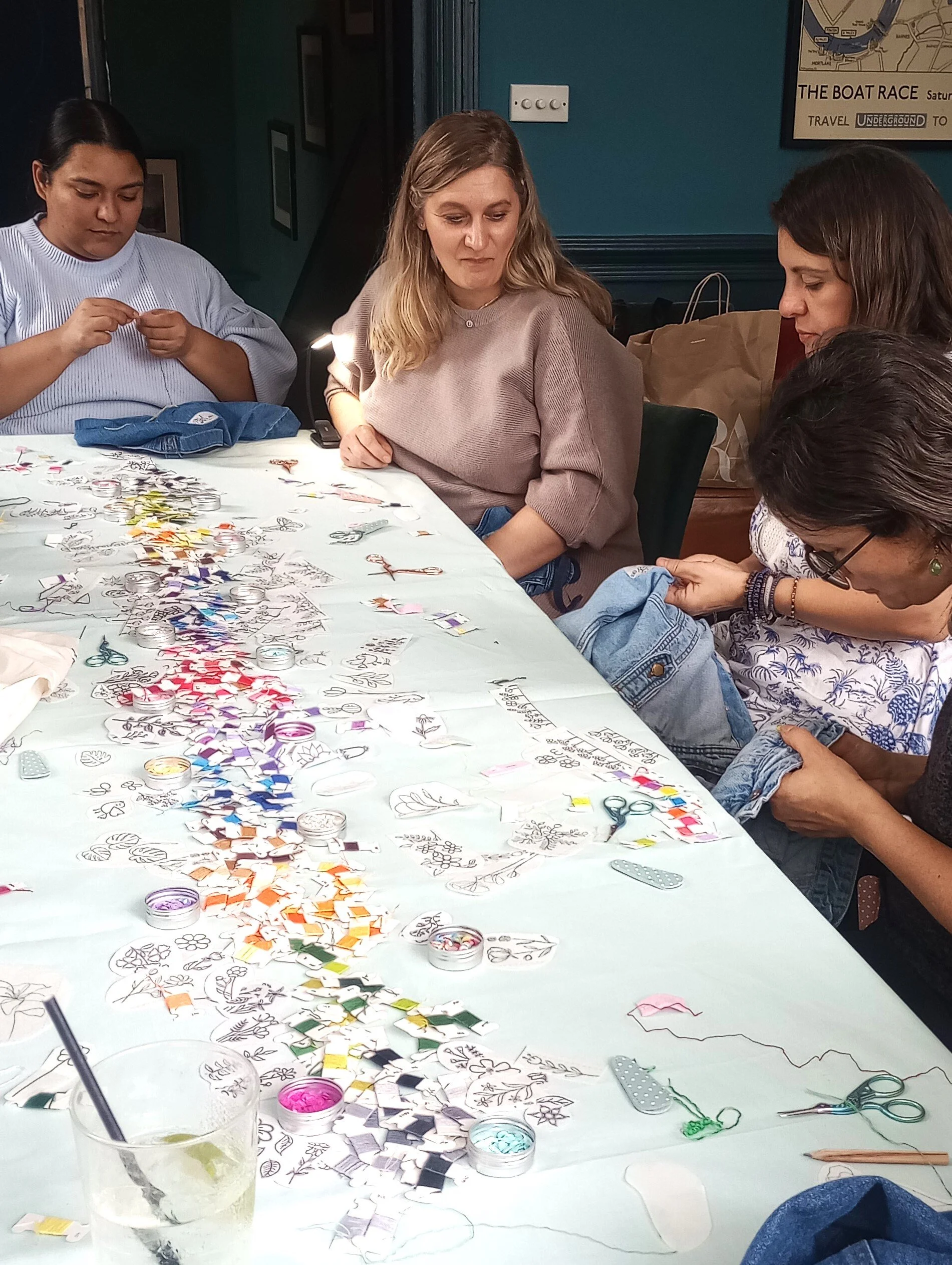 A table set up with colourful threads and beads for an embroidery workshop