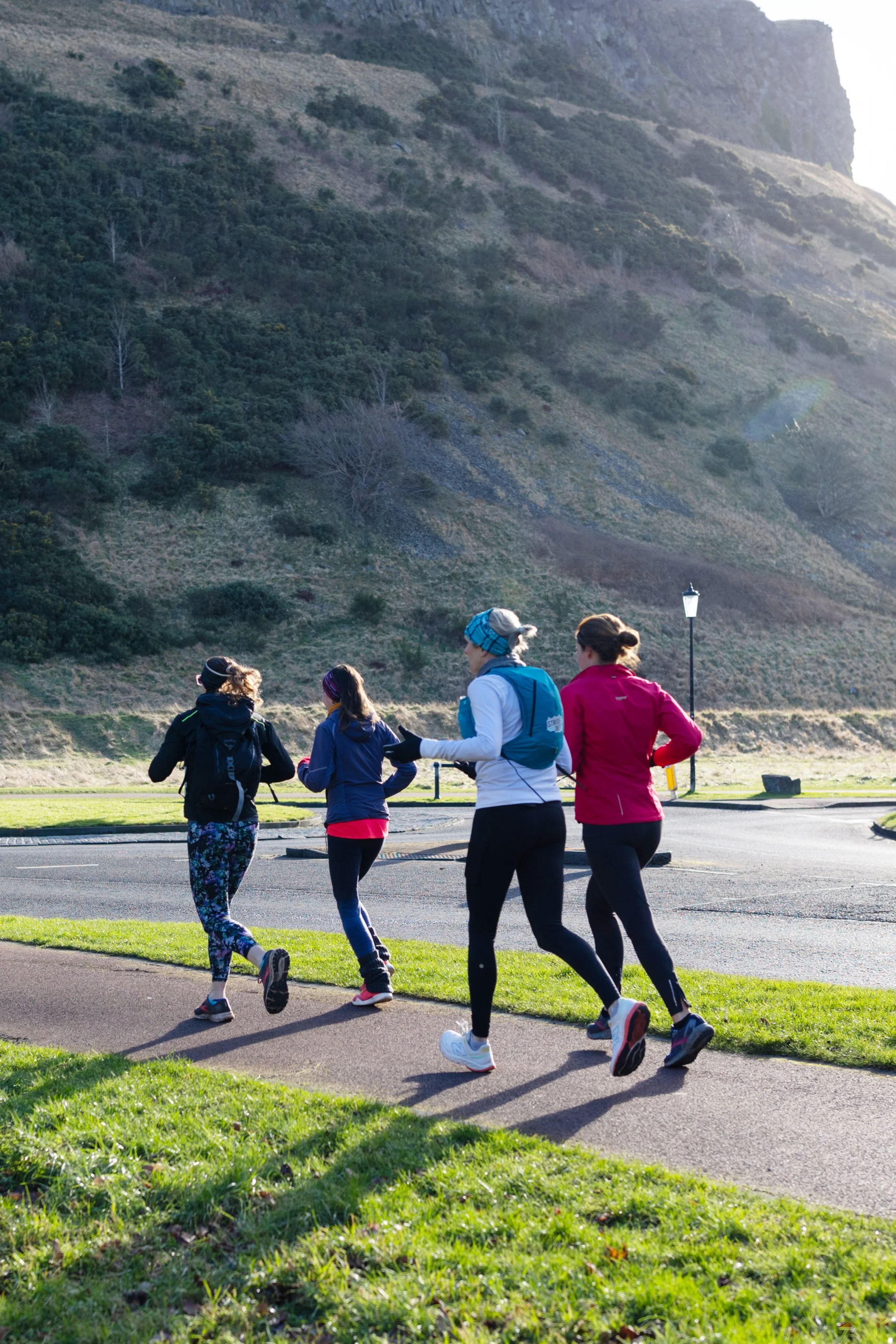 Jayne Lawson from Stride Out Running Tours leading group of runners at Holyrood Park