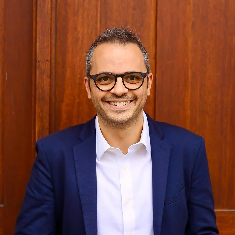 Psychiatrist smiling in picture with blue jacket.