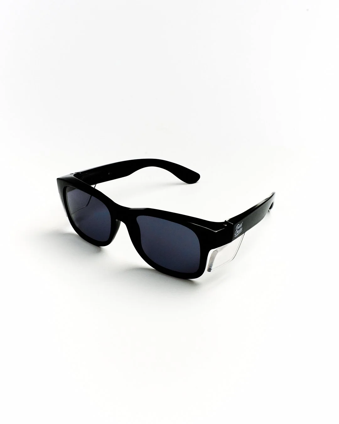 Black sunglasses with dark lenses on a white background.