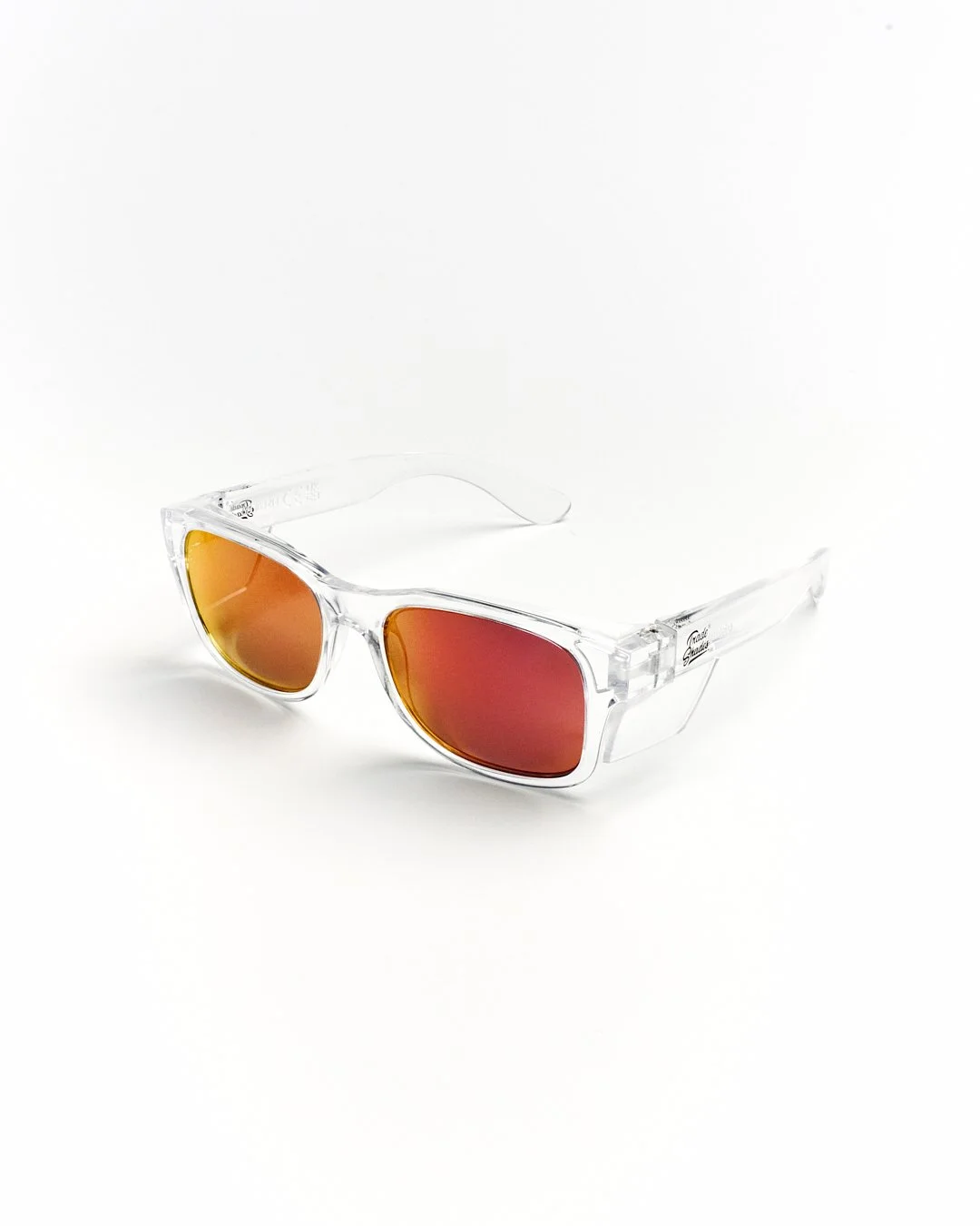 Pair of sunglasses with transparent frame and orange-red mirrored lenses on a white background.