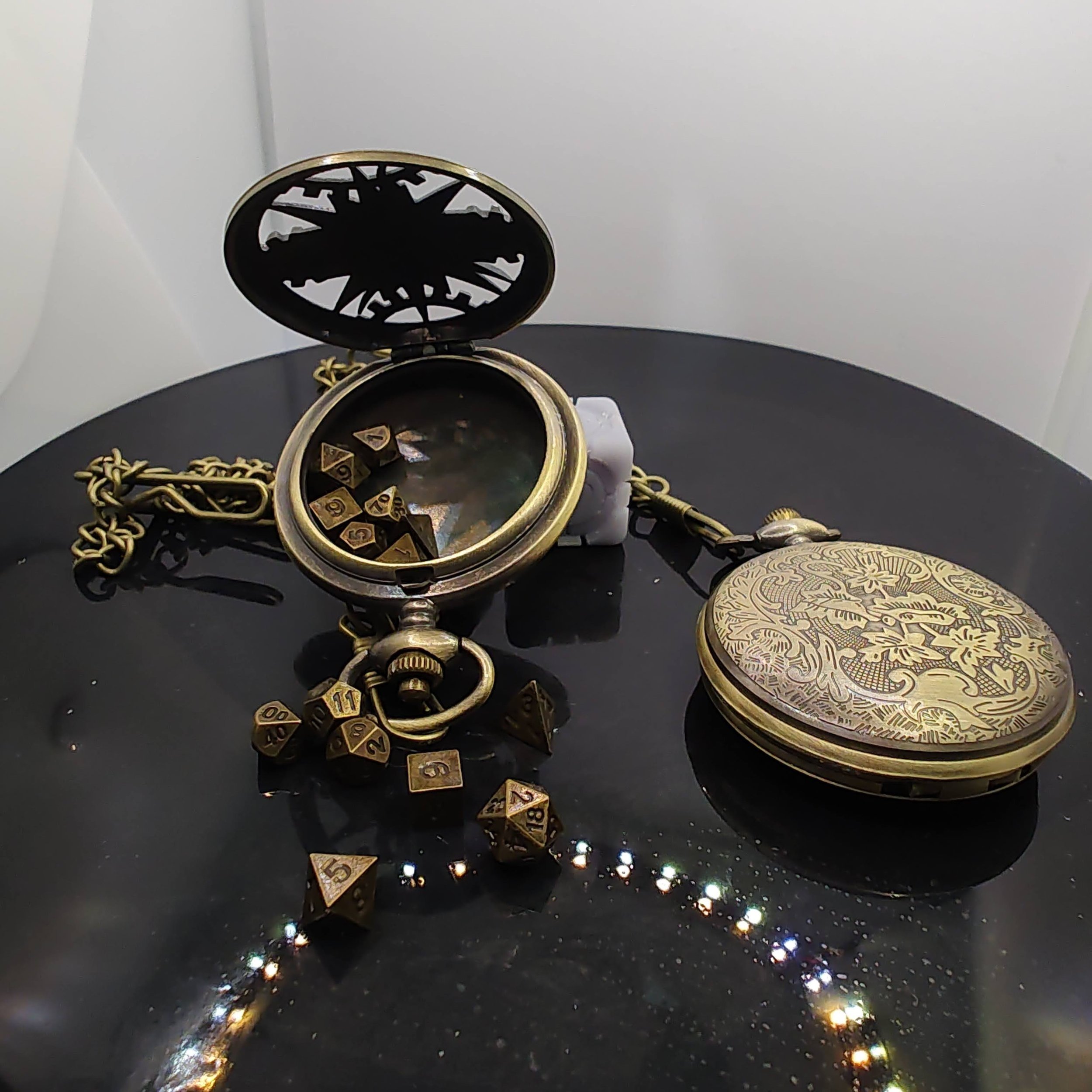 A bronze pocket watch opened to reveal a hidden compartment holding tiny metal RPG dice, featuring intricate clockwork engravings on the outer cover