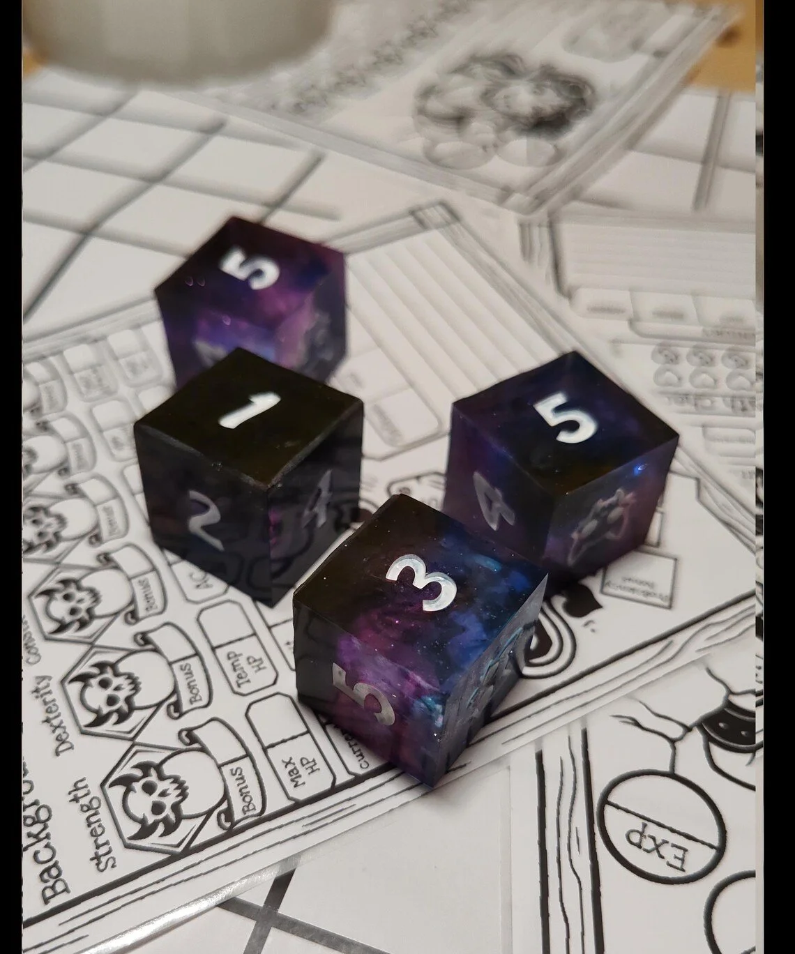 Four black dice with a galaxy pattern and white numbers on a game board with spaces, skull icons, and game instructions.