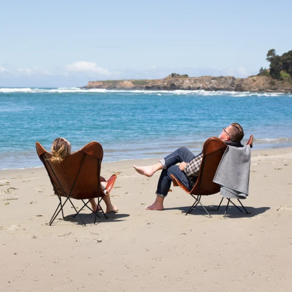 Couple relaxing on a beach at a California State Park, nearby  Mendocino Village and Mendocino Grove.
