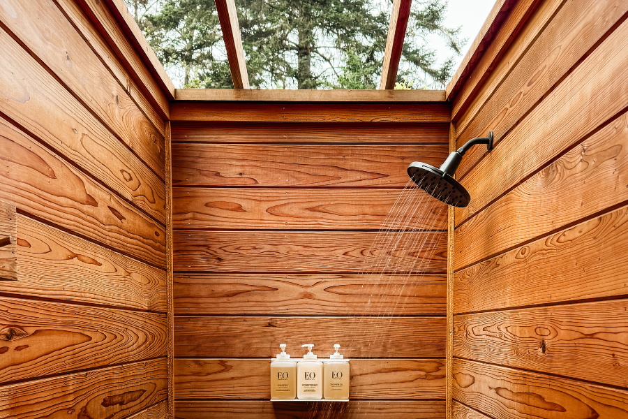 Outdoor redwood shower & sauna at Mendocino Grove featuring clean and private glamping bath facilities